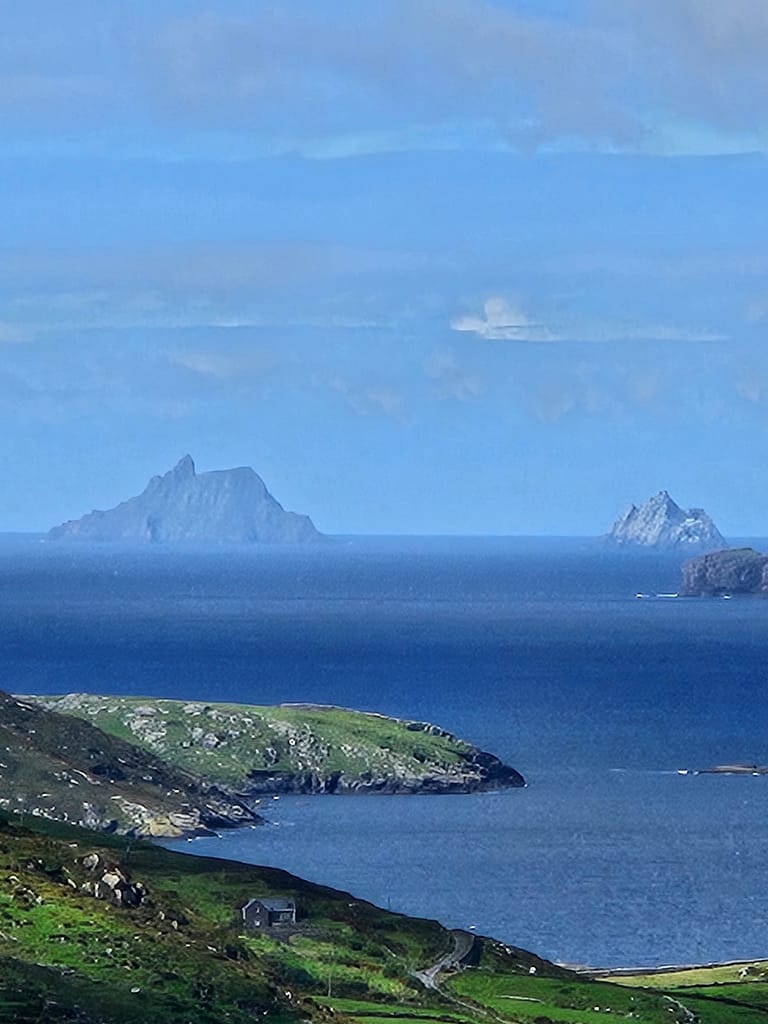 View of the rocky islands and blue sea on the coast of Ireland, looking down the Kerry Way.