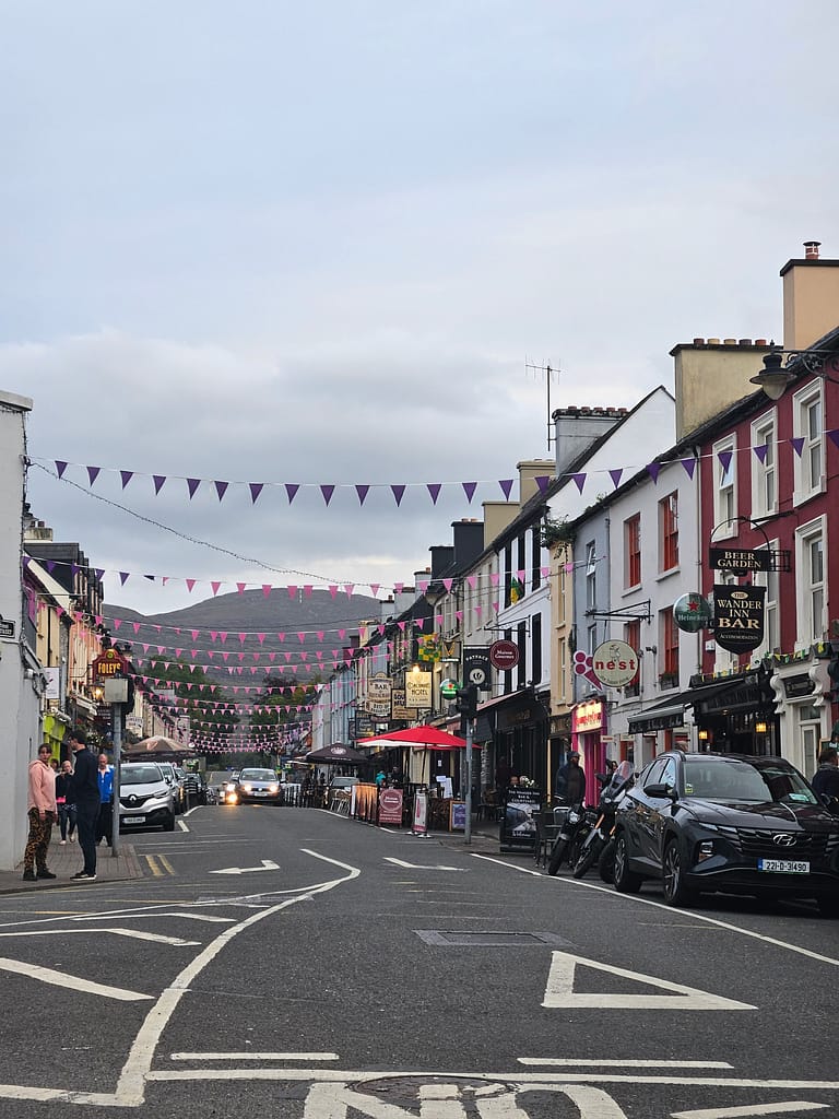 Colourful buildings and shops along the street in an Irish town.